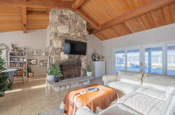 a bedroom with a bed and a flat tv screen