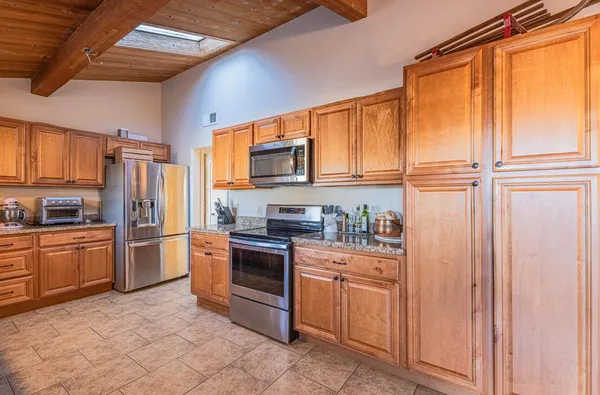 a bathroom with a granite countertop sink a toilet and shower