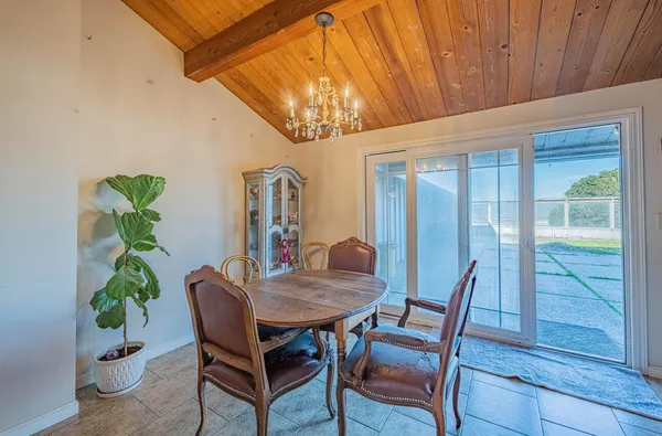 a bedroom with a bed and a table chair