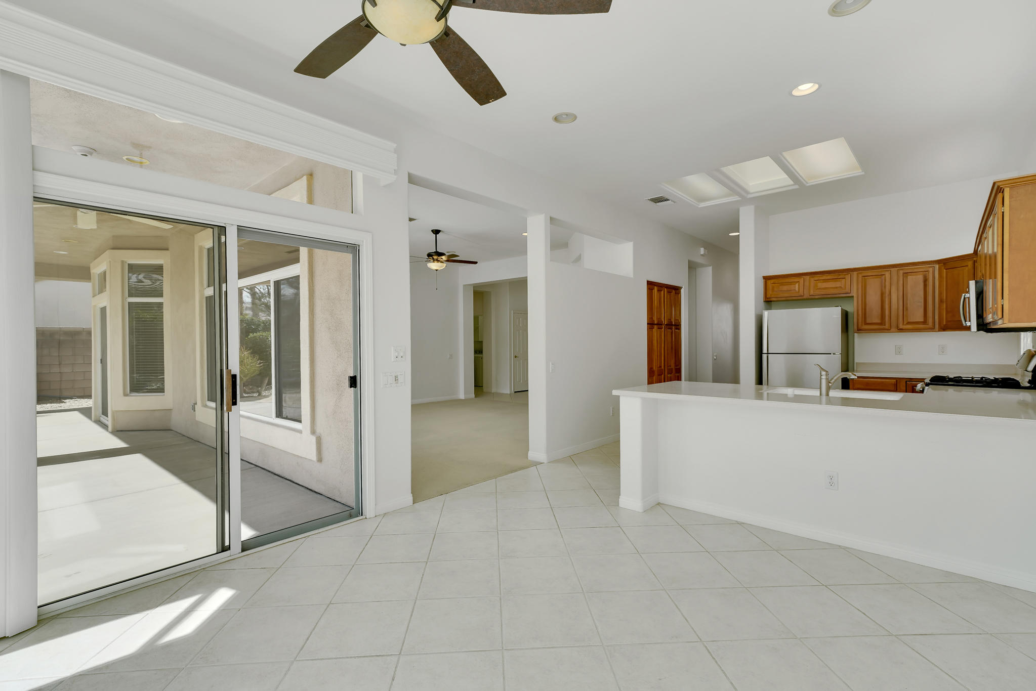78655 Morning Star Palm Desert, CA 92211 - Photo 12 of 23 a view of a living room and kitchen with stainless steel appliances