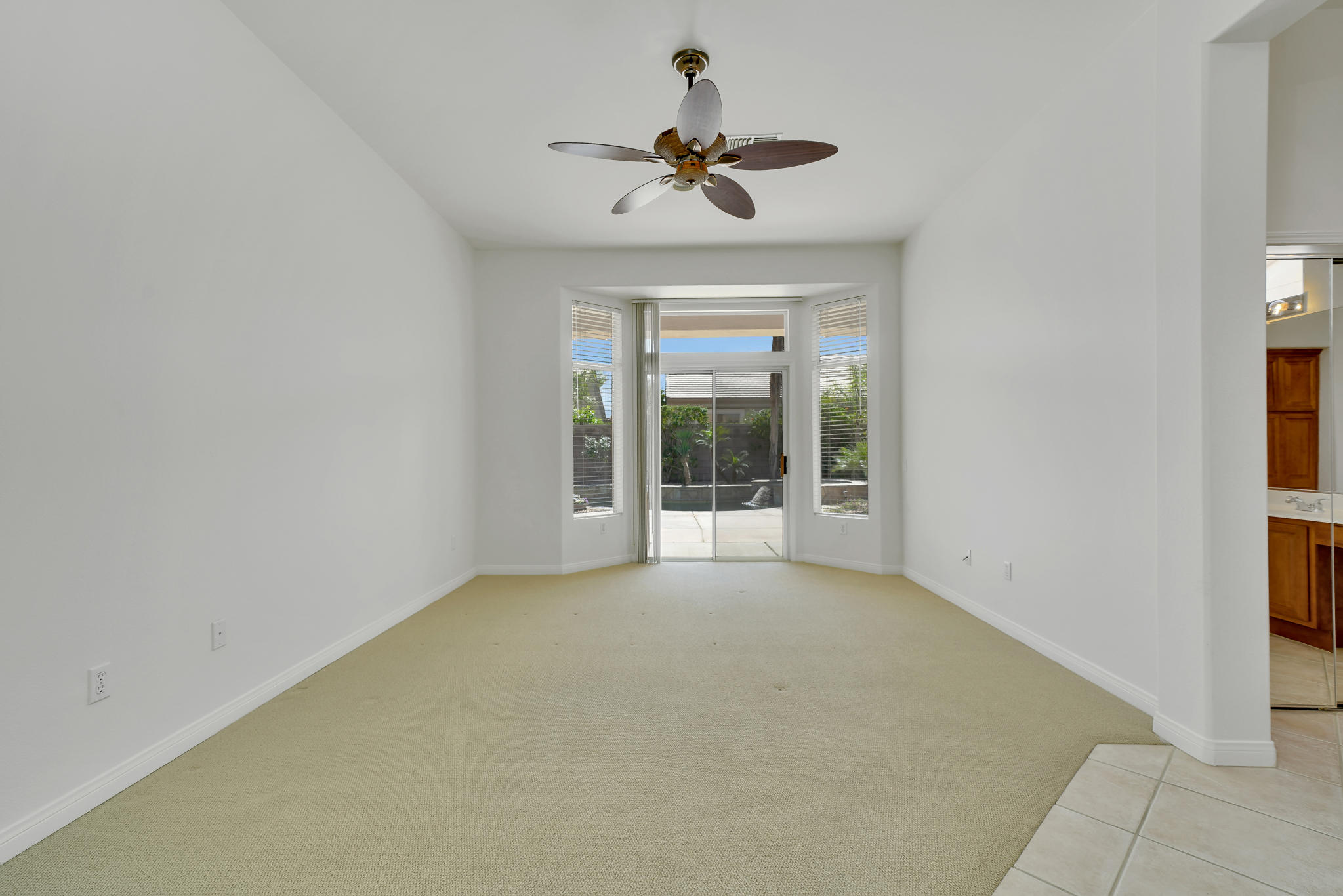 78655 Morning Star Palm Desert, CA 92211 - Photo 15 of 23 a view of an empty room with a ceiling fan