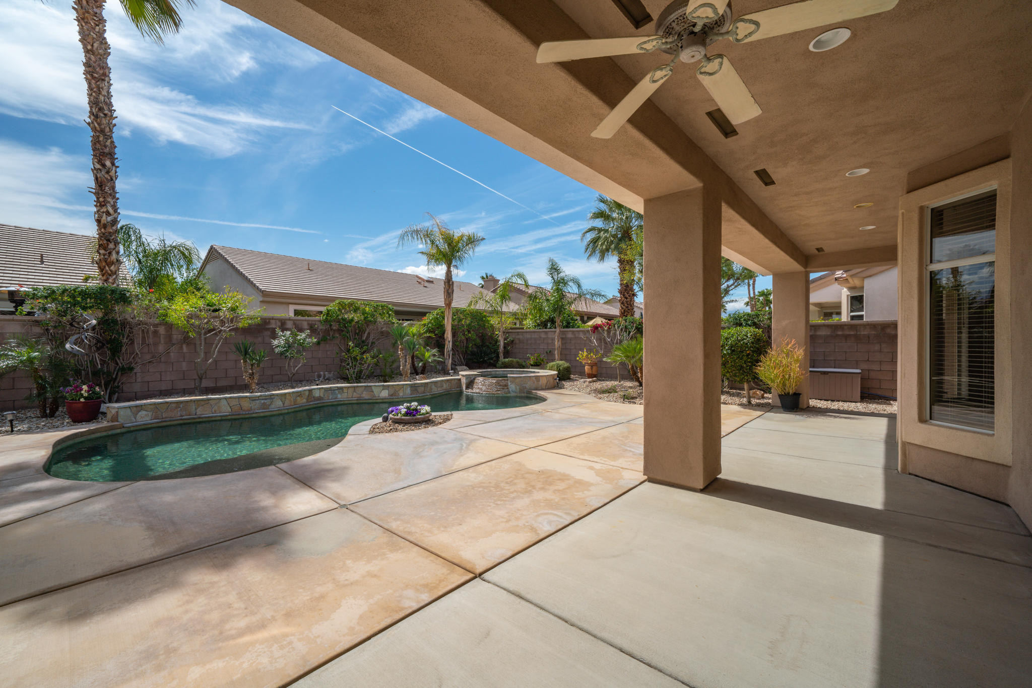 78655 Morning Star Palm Desert, CA 92211 - Photo 3 of 23 a view of a patio with a table and chairs under an umbrella