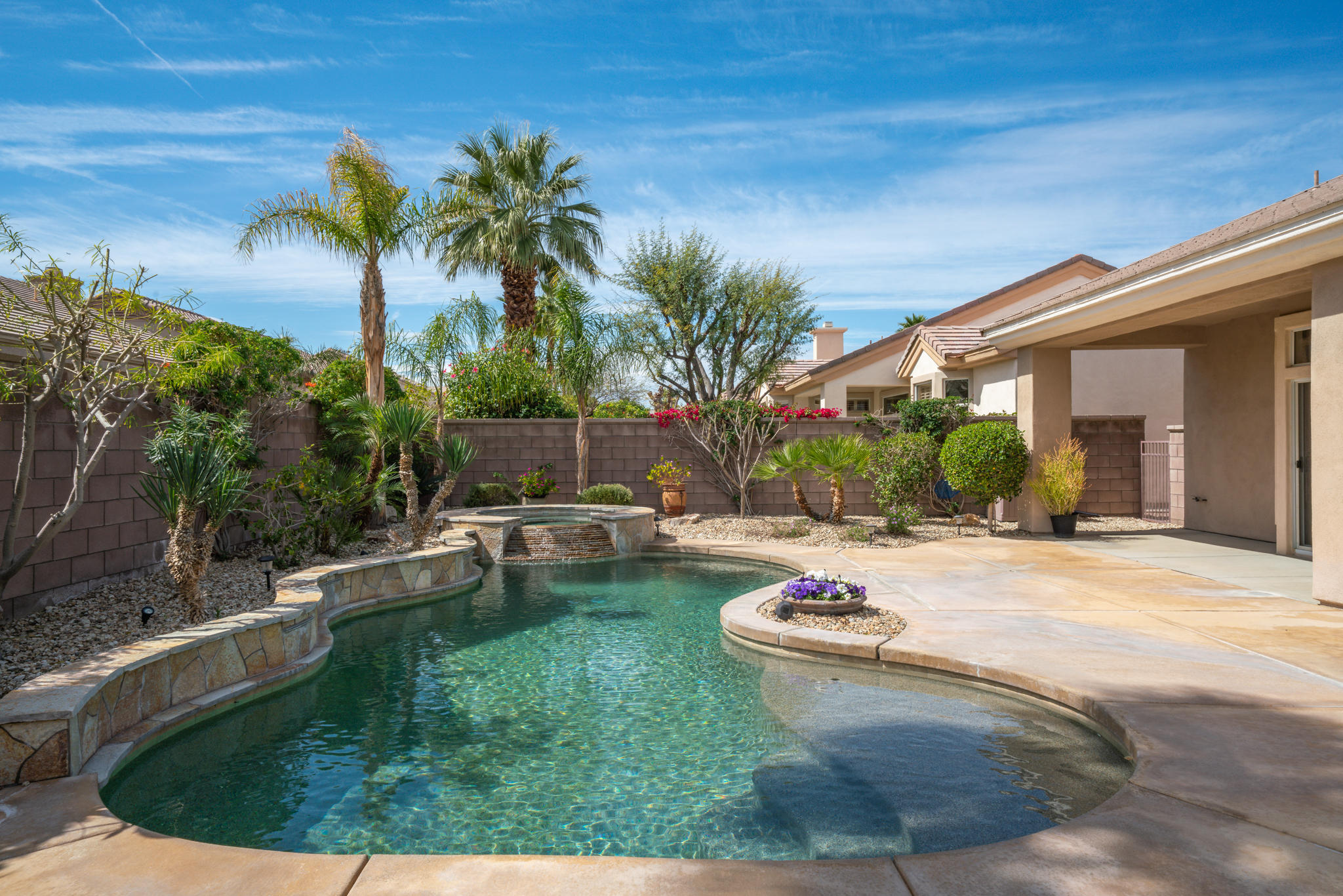 78655 Morning Star Palm Desert, CA 92211 - Photo 22 of 23 a view of a backyard with plants and swimming pool