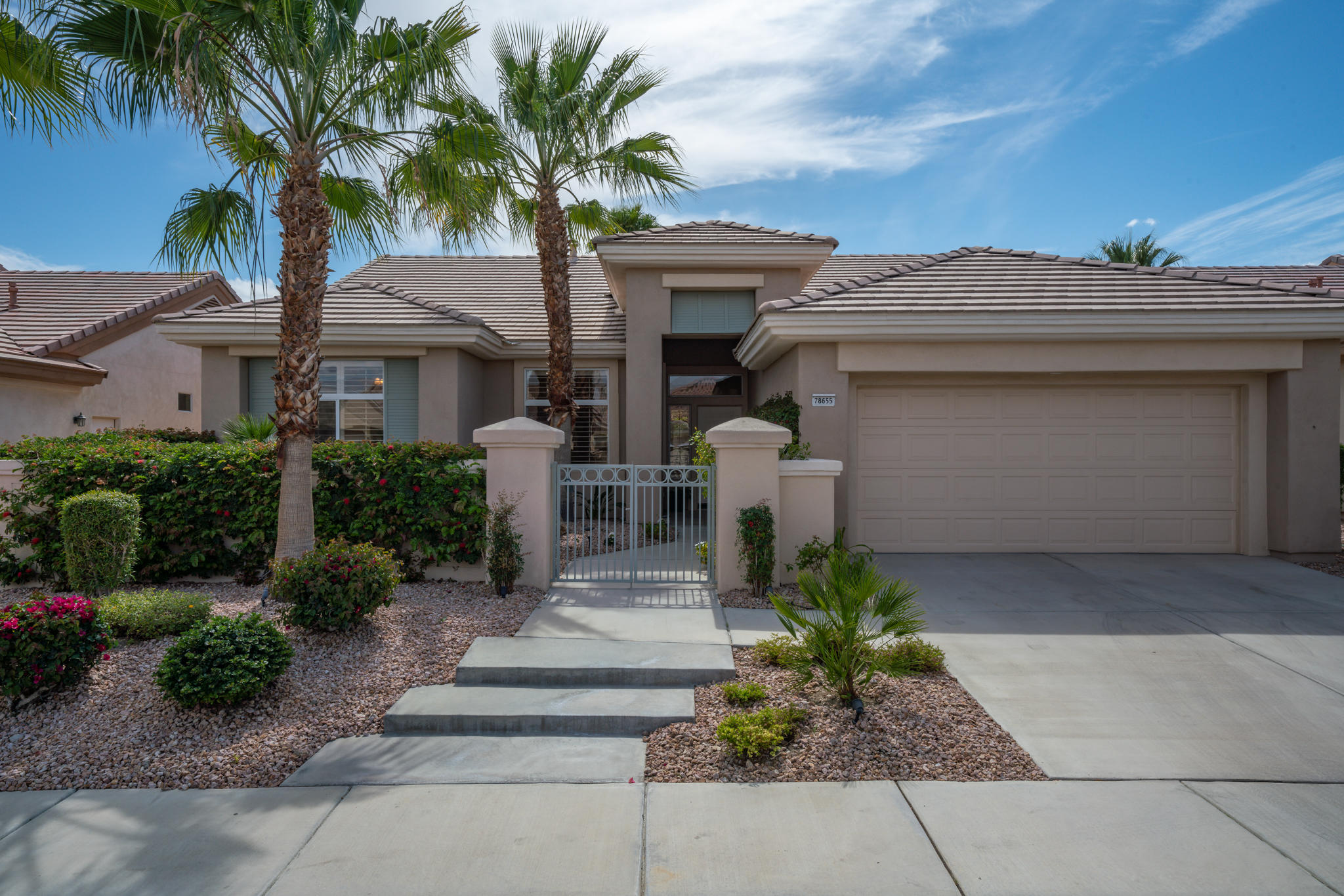 78655 Morning Star Palm Desert, CA 92211 - Photo 5 of 23 a front view of a house with garden