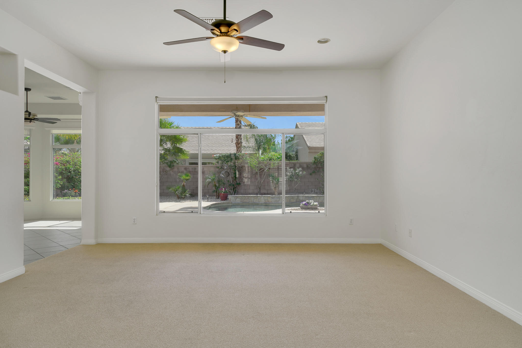 78655 Morning Star Palm Desert, CA 92211 - Photo 8 of 23 an empty room with a window and a ceiling fan