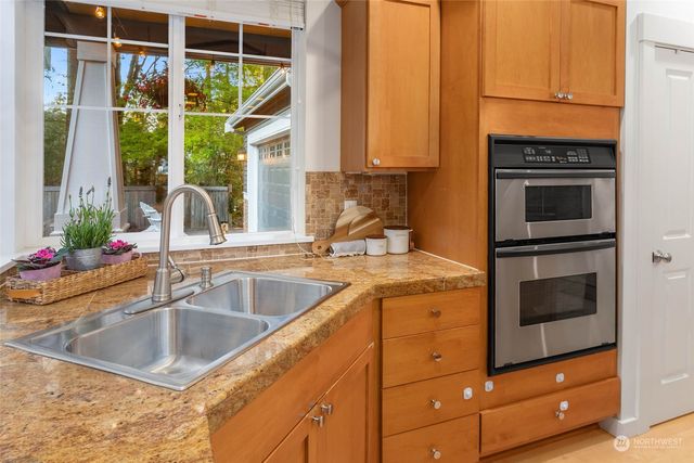 a kitchen with a sink and a stove top oven