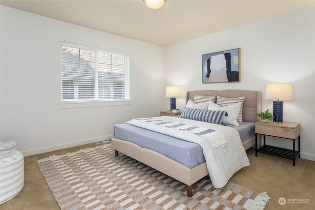 a bedroom with a bed and a night stand