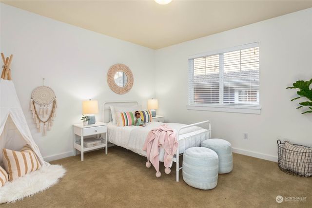 a bedroom with bed and a window