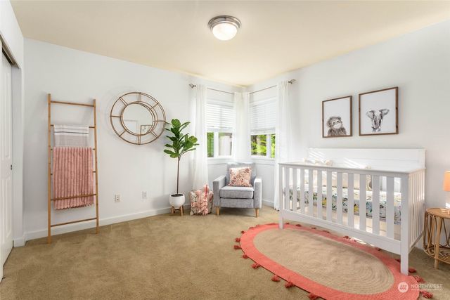 a living room with furniture a rug and white walls