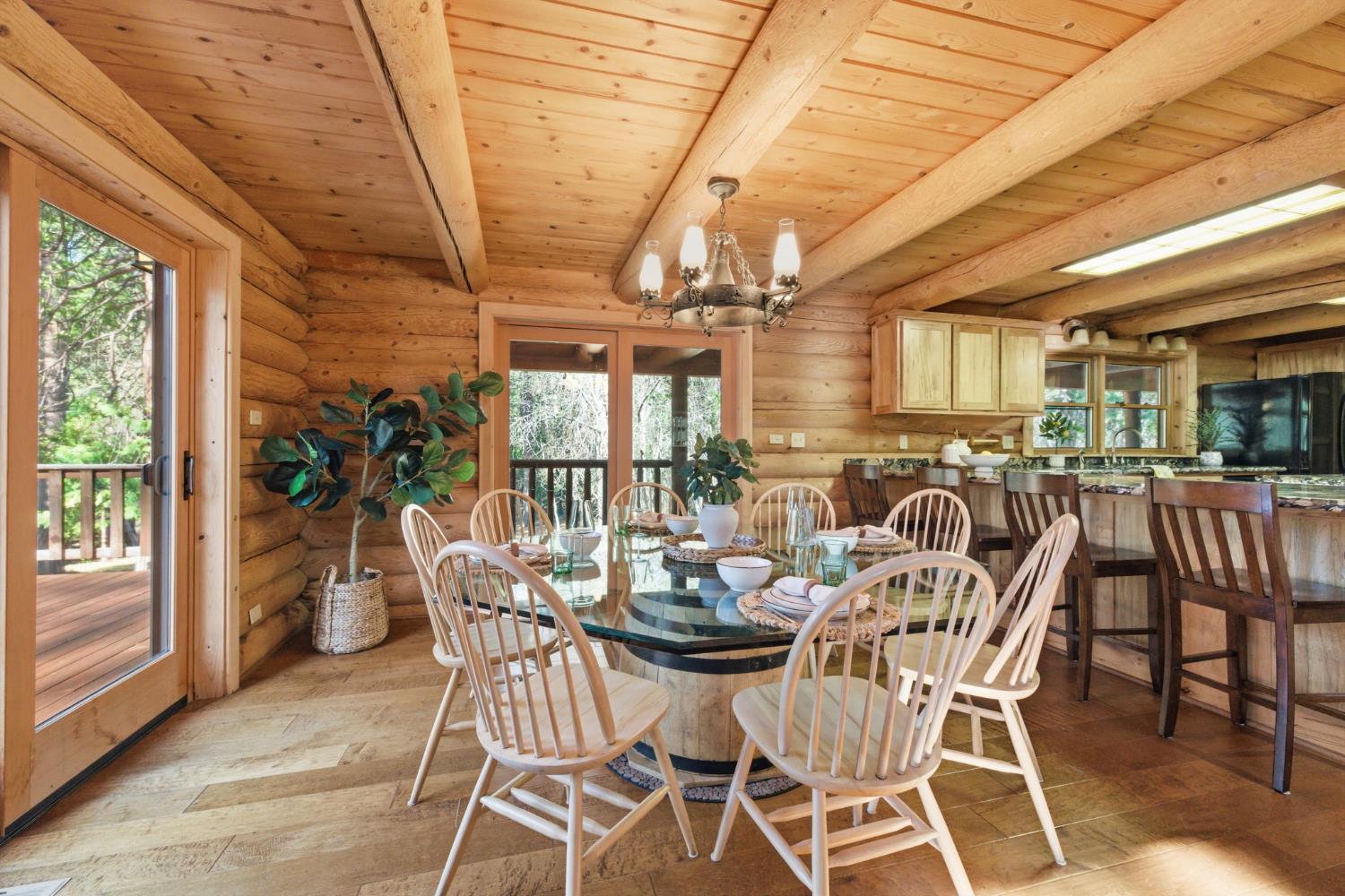 2428 Rancho Paradiso Arnold, CA 95223 - Photo 23 of 67 a dining room with furniture a chandelier and wooden floor