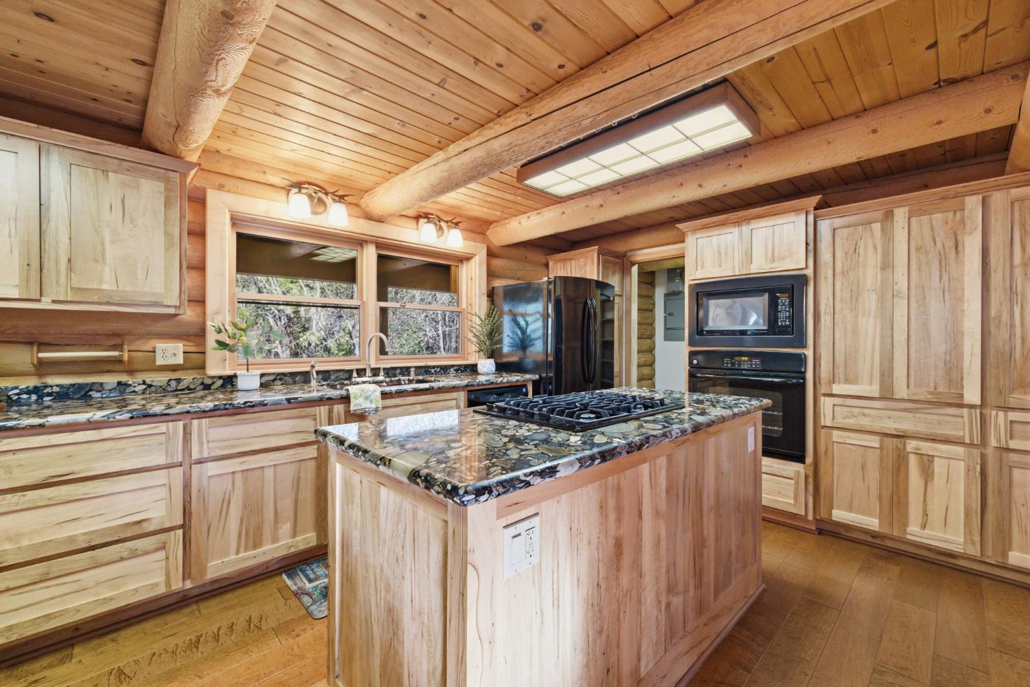 2428 Rancho Paradiso Arnold, CA 95223 - Photo 26 of 67 a kitchen with stainless steel appliances granite countertop a sink stove and refrigerator
