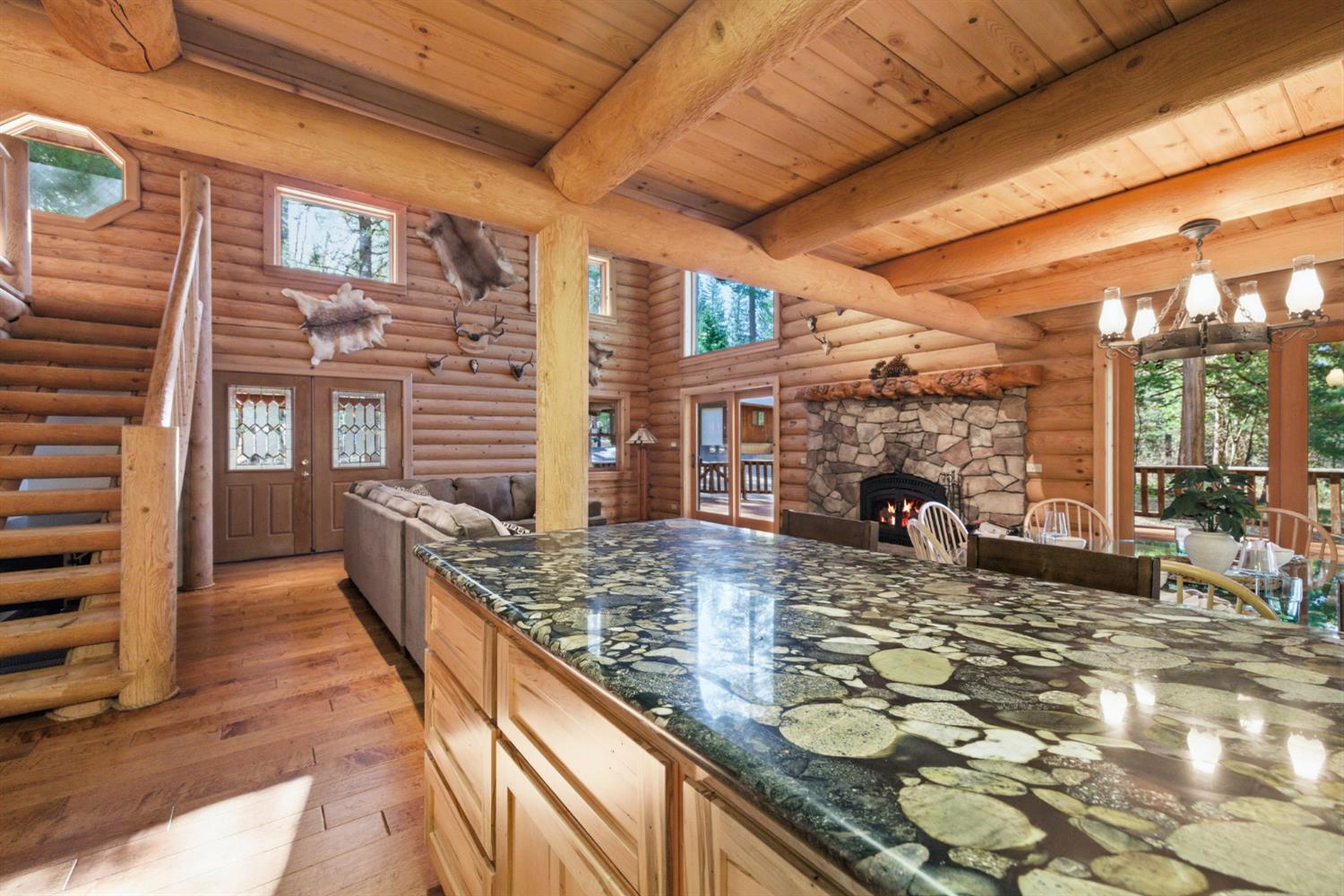 2428 Rancho Paradiso Arnold, CA 95223 - Photo 27 of 67 River rock granite countertops, custom cabinetry with soft-close drawers, a massive pantry, and direct deck access for seamless indoor-outdoor living.