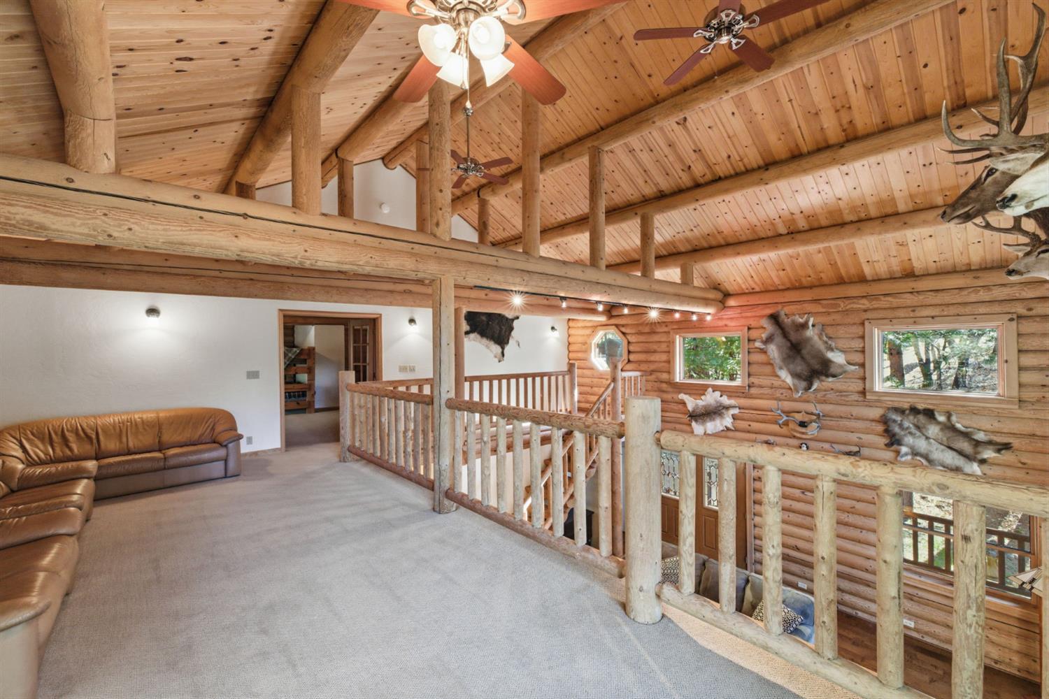 2428 Rancho Paradiso Arnold, CA 95223 - Photo 35 of 67 Expansive upper-level loft with a striking arched window and private slider to a covered deck. This versatile retreat serves perfectly as a home office, media space, or extra lounge area.