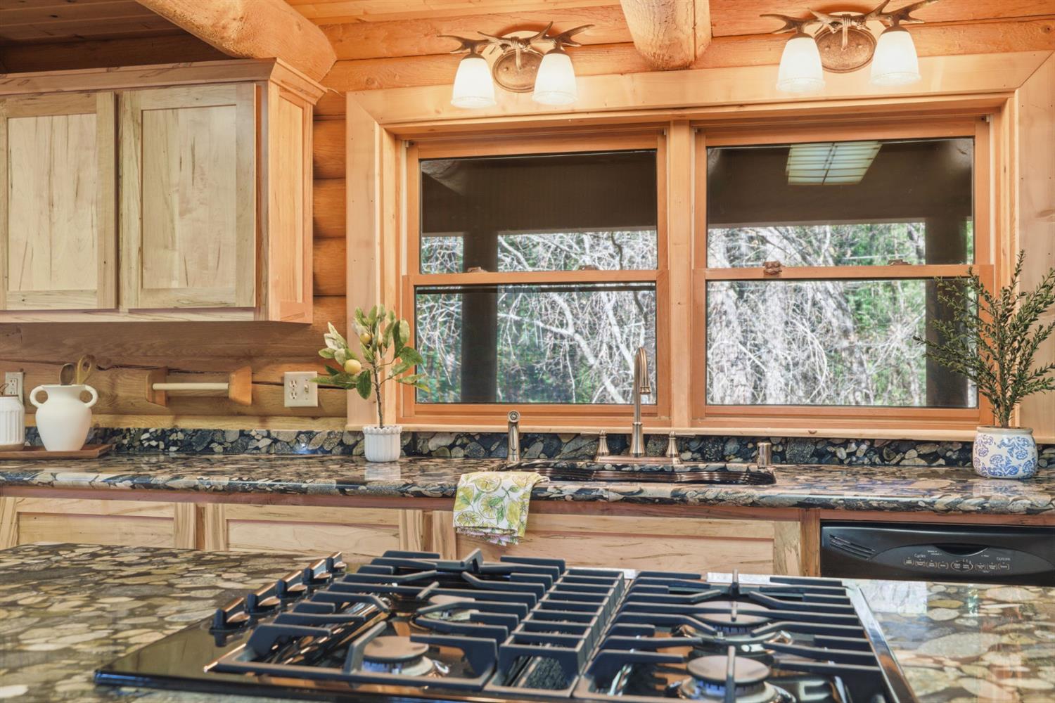 2428 Rancho Paradiso Arnold, CA 95223 - Photo 43 of 67 a kitchen with a stove a sink and a window