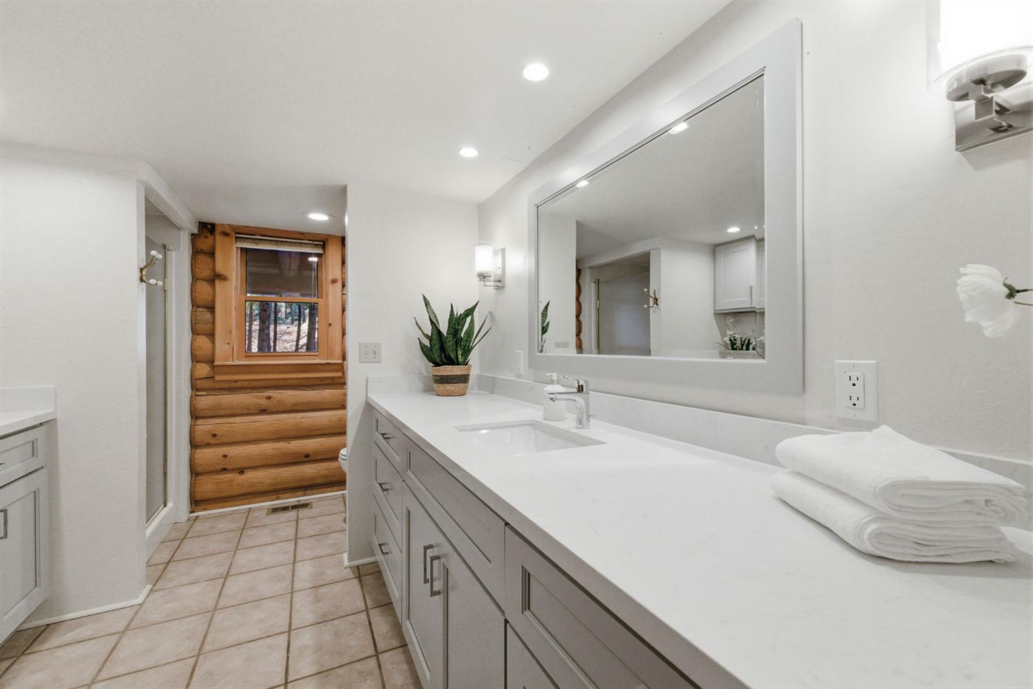 2428 Rancho Paradiso Arnold, CA 95223 - Photo 10 of 67 a bathroom with a sink a vanity and a mirror
