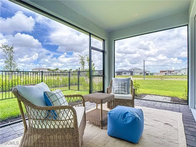 a view of a house with a yard and a large tree