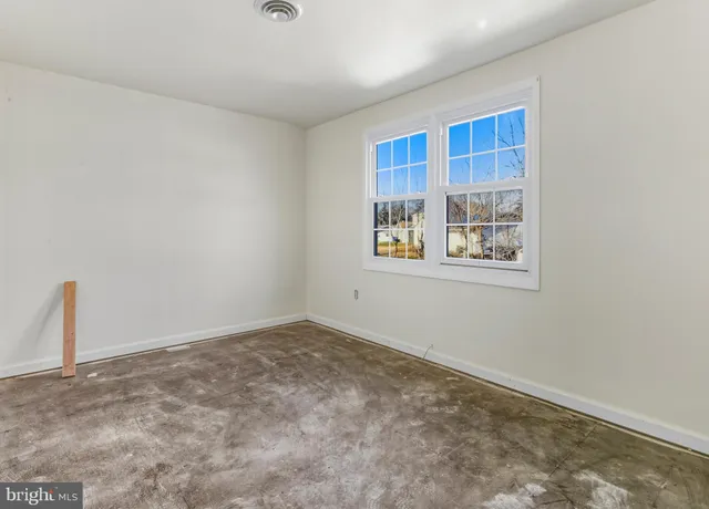 a view of house with yard and sitting area