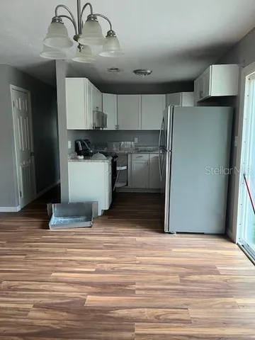 a room with wooden cabinets and ceiling fan
