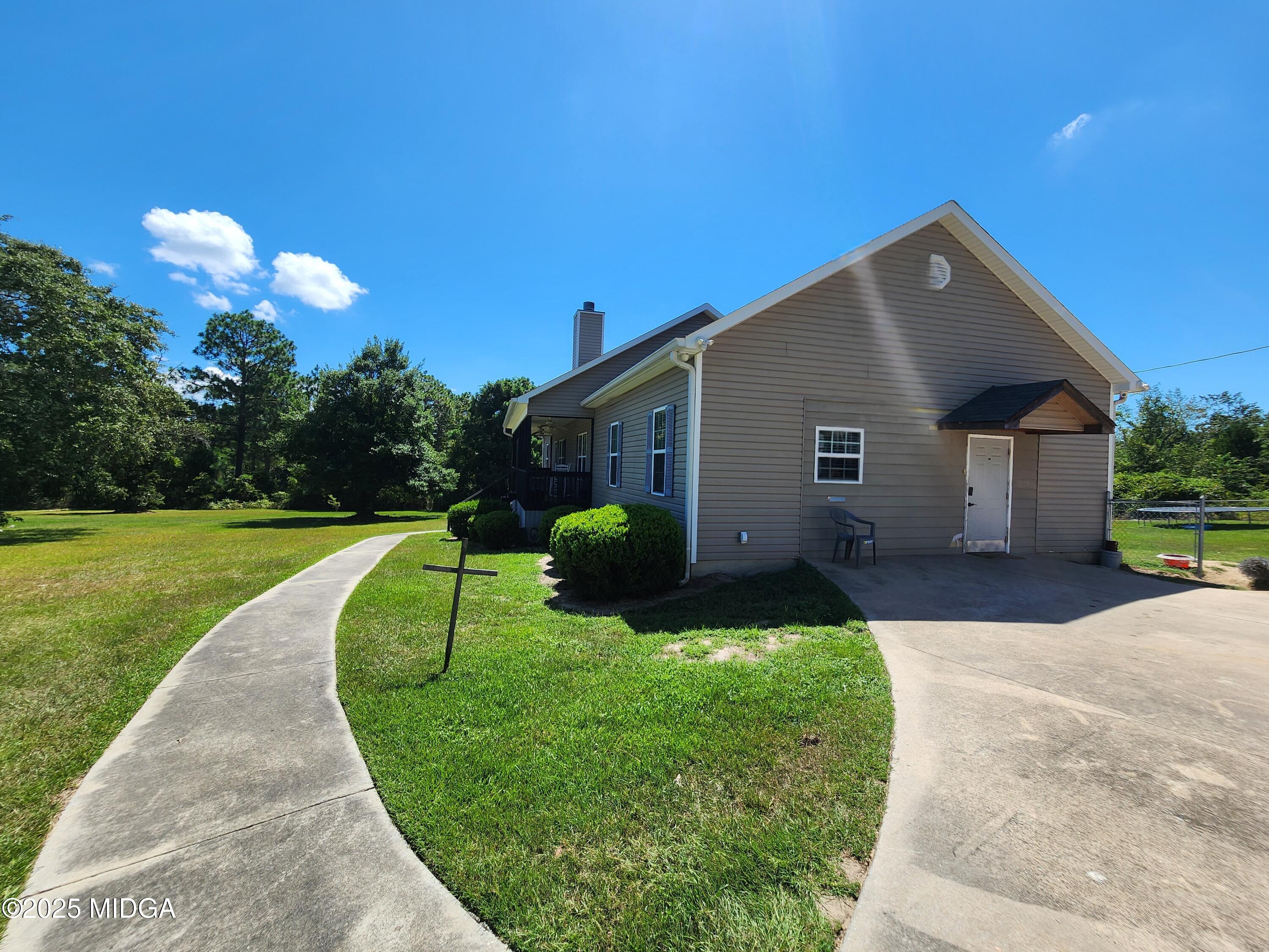 702 Carl Sutton Road Lizella, GA 31052 - Photo 3 of 43 a front view of a house with yard and green space