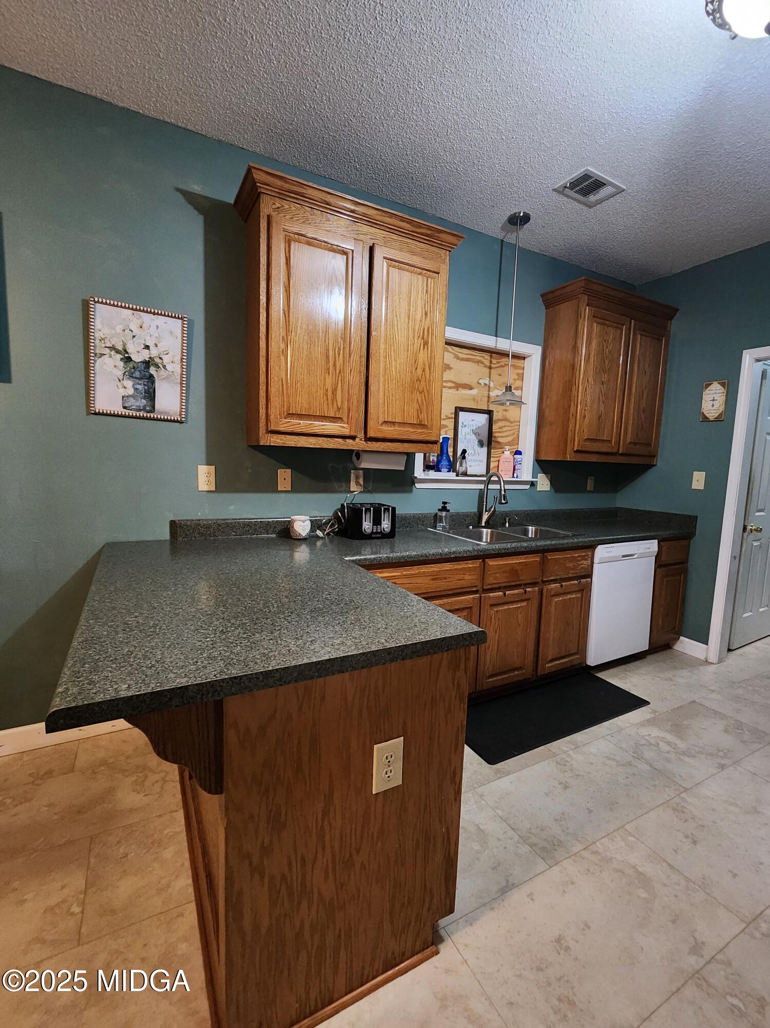 702 Carl Sutton Road Lizella, GA 31052 - Photo 8 of 43 a kitchen with granite countertop a sink a stove a oven a window cabinets and a dining table