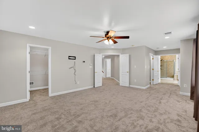 a view of a hallway with wooden shelves