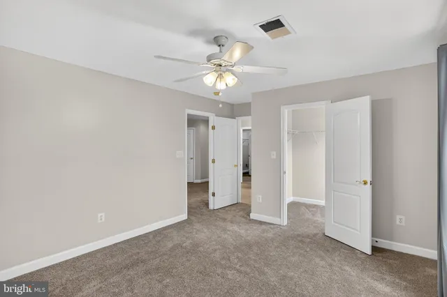 a bathroom with a toilet a sink a tub and a mirror