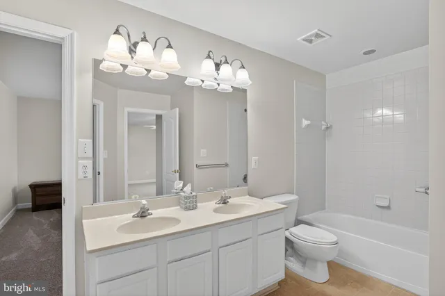 a view of a livingroom with wooden floor and stairs