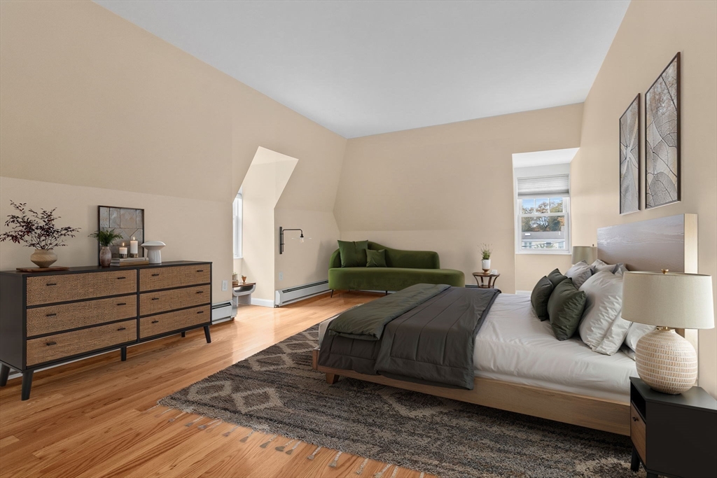 20 Ash Street, Unit 3 Danvers, MA 01923 - Photo 19 of 39 a bedroom with a bed and wooden floor