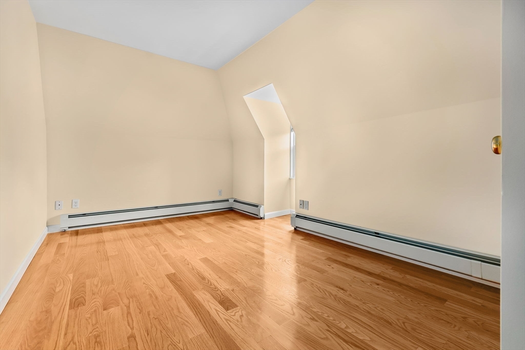 20 Ash Street, Unit 3 Danvers, MA 01923 - Photo 22 of 39 a view of an empty room with wooden floor
