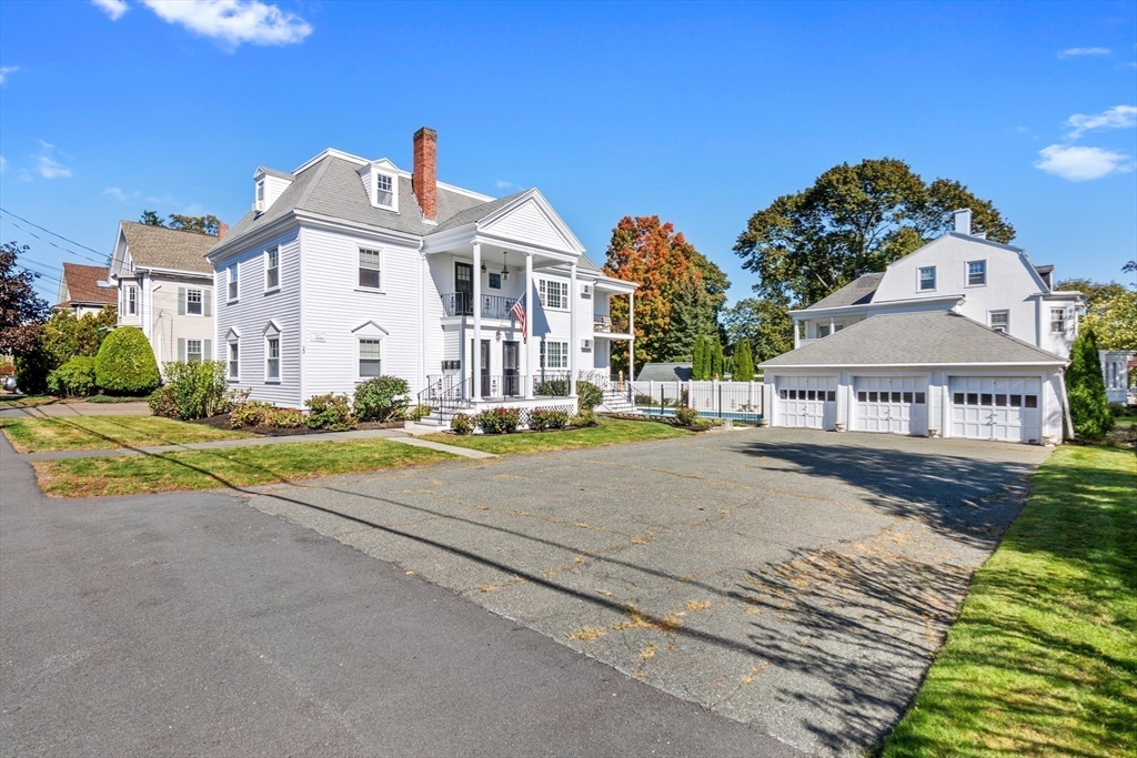 20 Ash Street, Unit 3 Danvers, MA 01923 - Photo 29 of 39 a view of a white house with a big yard and large trees