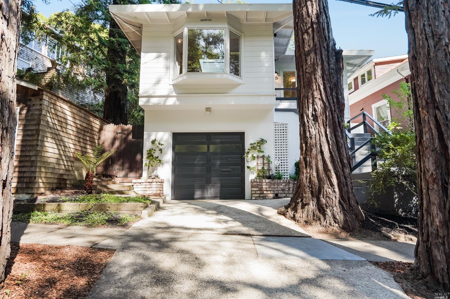 74 Madrone Avenue Larkspur, CA 94939 - Photo 1 of 1 a view of a brick house with plants and large tree