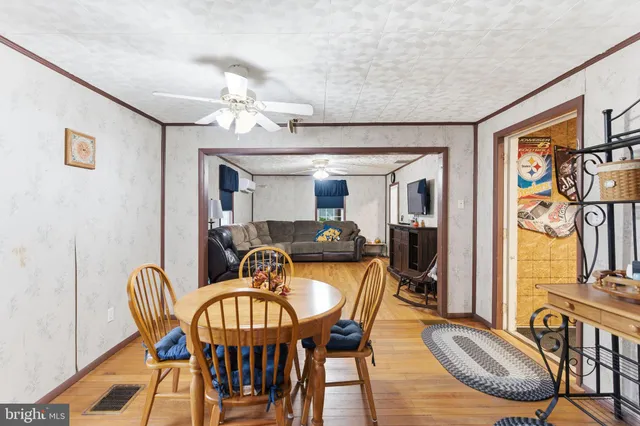 a kitchen with stainless steel appliances granite countertop a stove a sink dishwasher and cabinets with wooden floor