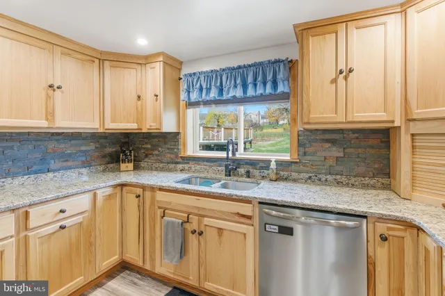 a view of a dining room with furniture and a chandelier