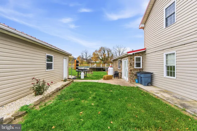 an aerial view of a house with garden space and a patio