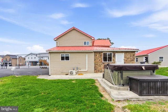 a view of a yard with a table and chairs under an umbrella