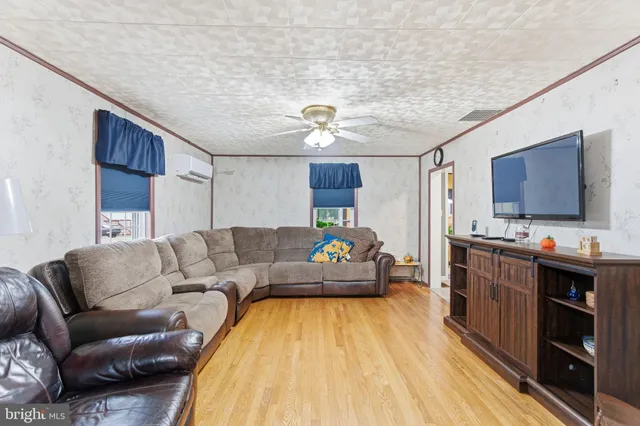 a dining room with furniture a chandelier and wooden floor