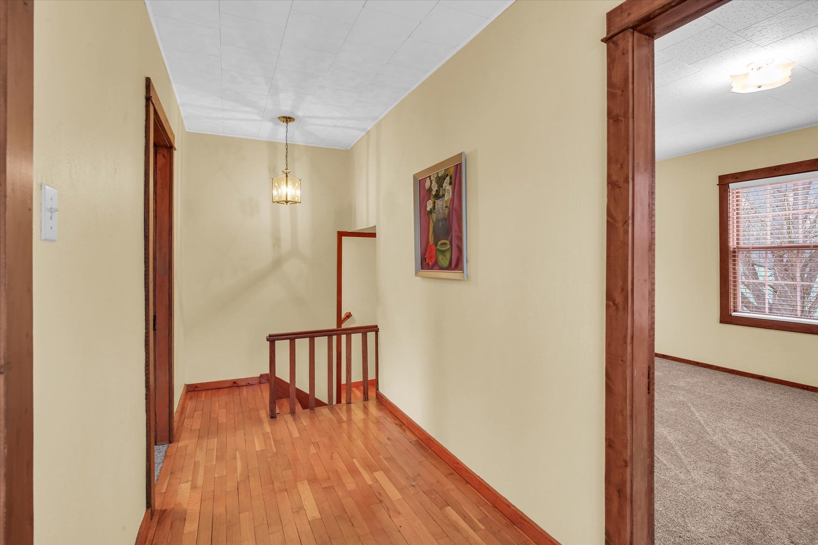 112 North Front Street Sadorus, IL 61872 - Photo 12 of 44 a view of hallway with a large window and wooden floor