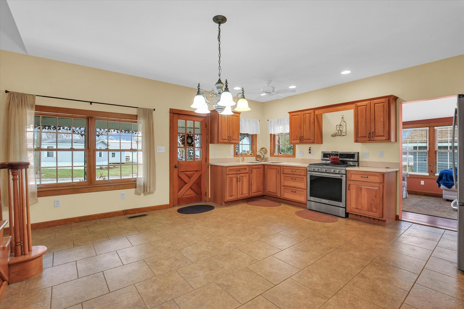 112 North Front Street Sadorus, IL 61872 - Photo 10 of 44 a open kitchen with cabinets a stove and a chandelier