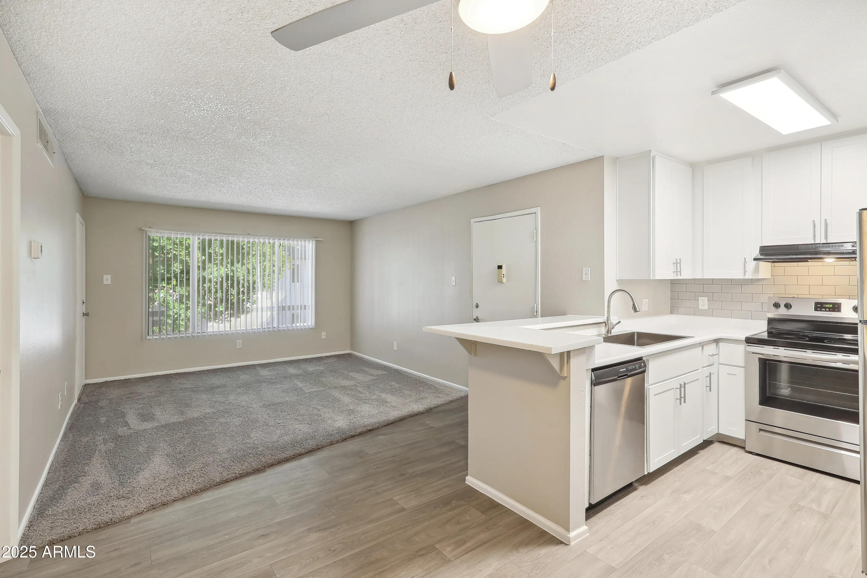 1620 West Southern Avenue, Unit S1 Mesa, AZ 85202 - Photo 2 of 15 a kitchen with a stove and a sink