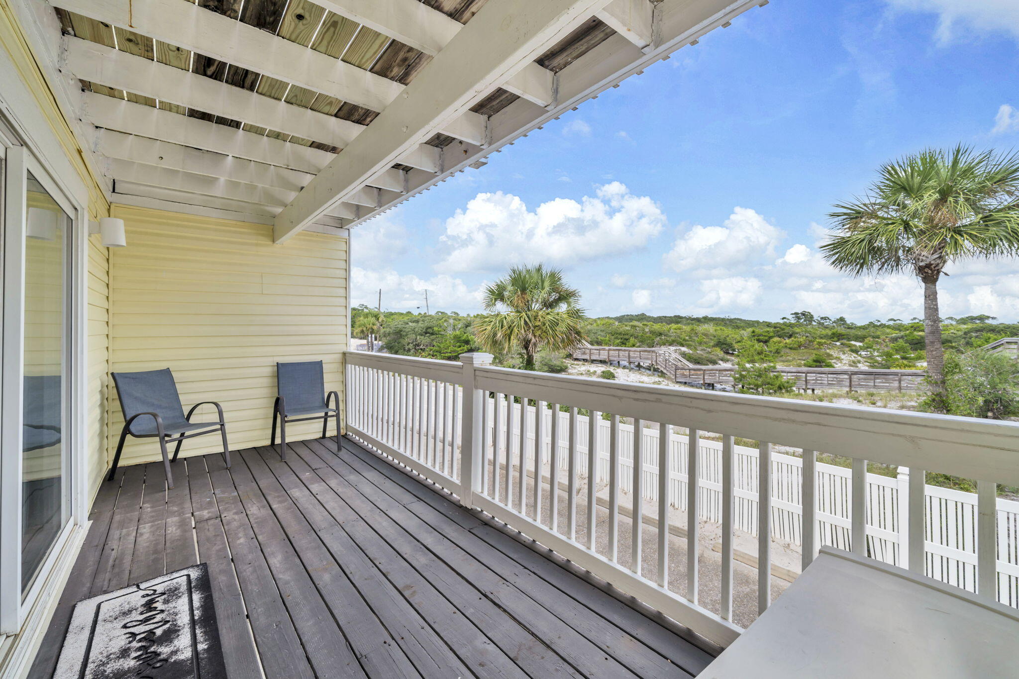 228 Walton Magnolia Lane, Unit 4 Inlet Beach, FL 32461 - Photo 12 of 45 a view of balcony with wooden floor and fence