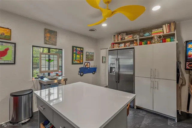 a kitchen with refrigerator and window
