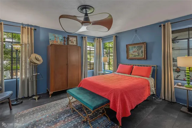 a bedroom with a bed and a mirror