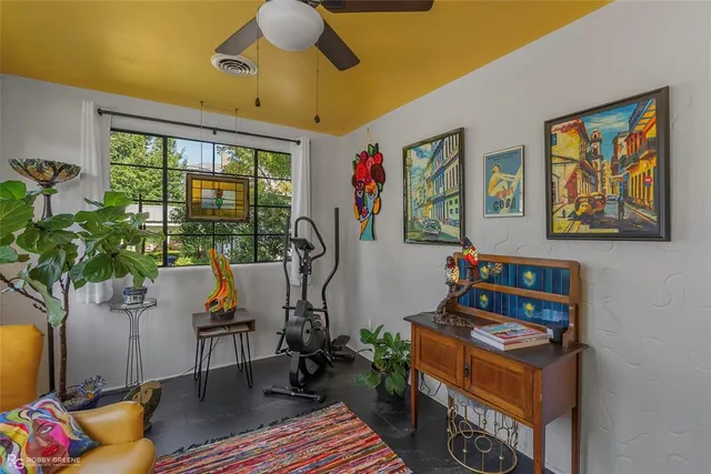 a living room with furniture and a potted plant