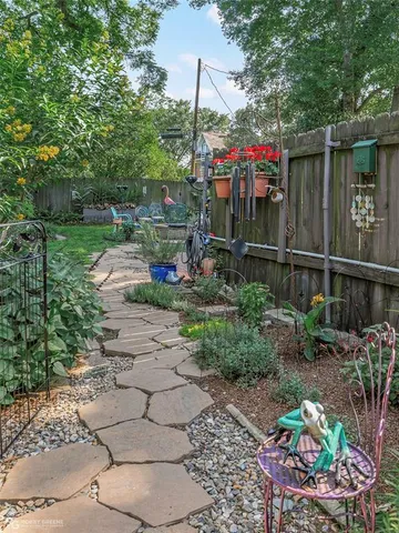 a childrens park with lots of green space and fountain