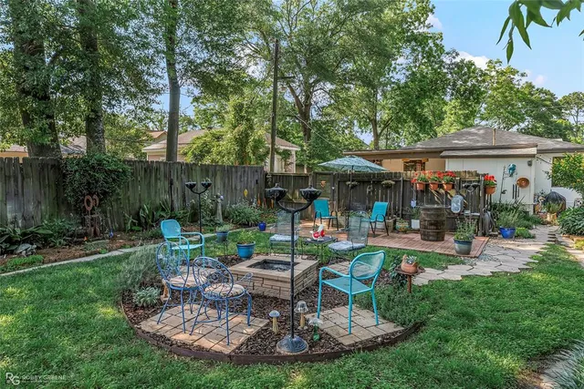 a view of a house with backyard and sitting area