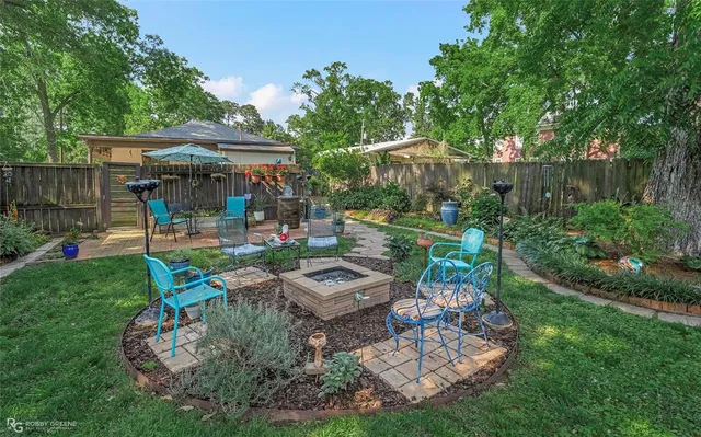 a view of a backyard with plants and a patio