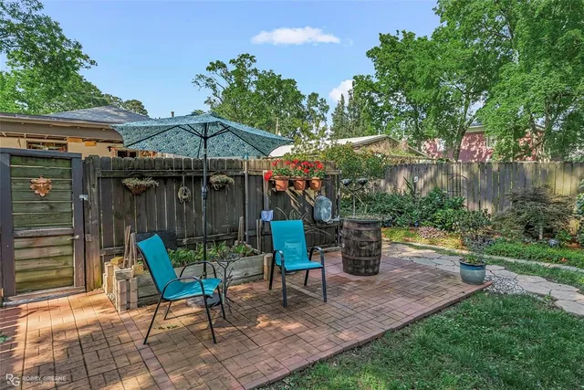 a view of a chairs and table in backyard of the house