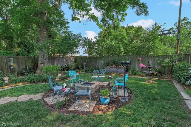 a view of a chair and table in the garden