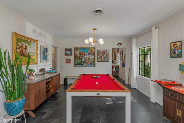 a room with furniture a chandelier a rug and a window