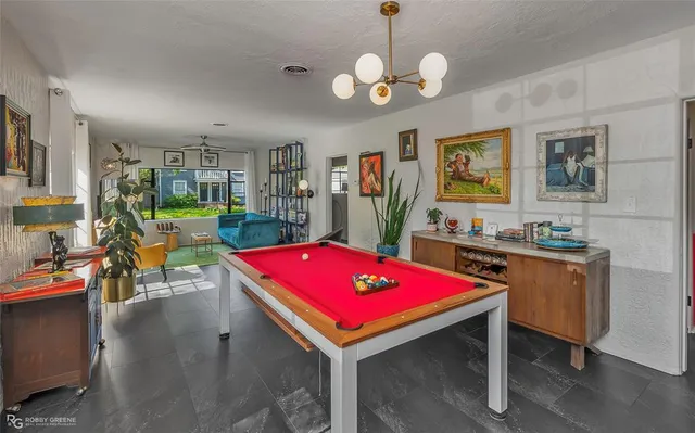 a room with furniture pool table and flat screen tv